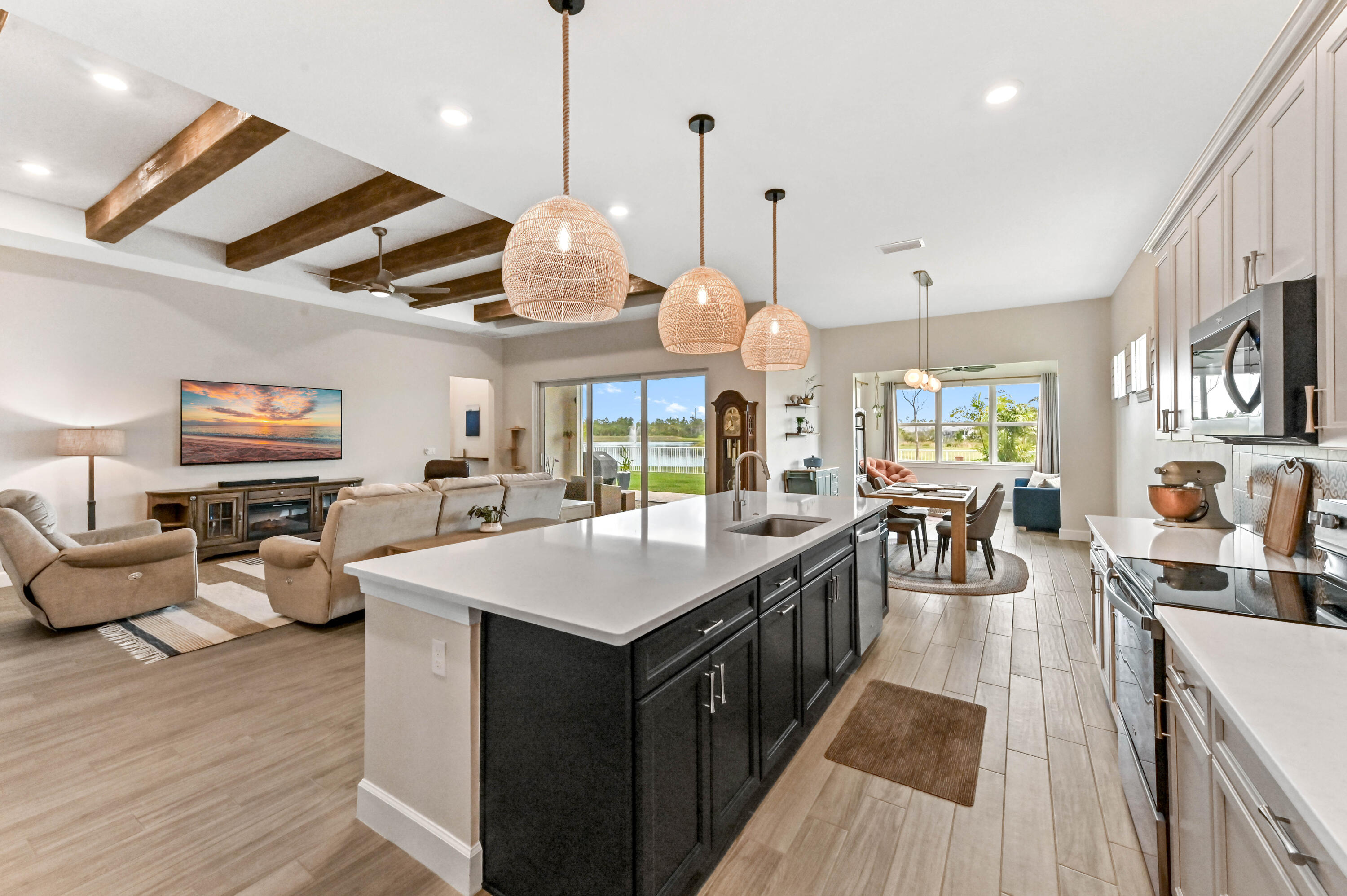 9891 Southwest Legacy Drive Stuart, FL 34997 - Photo 10 of 55 a large kitchen with stainless steel appliances kitchen island dining table and chairs