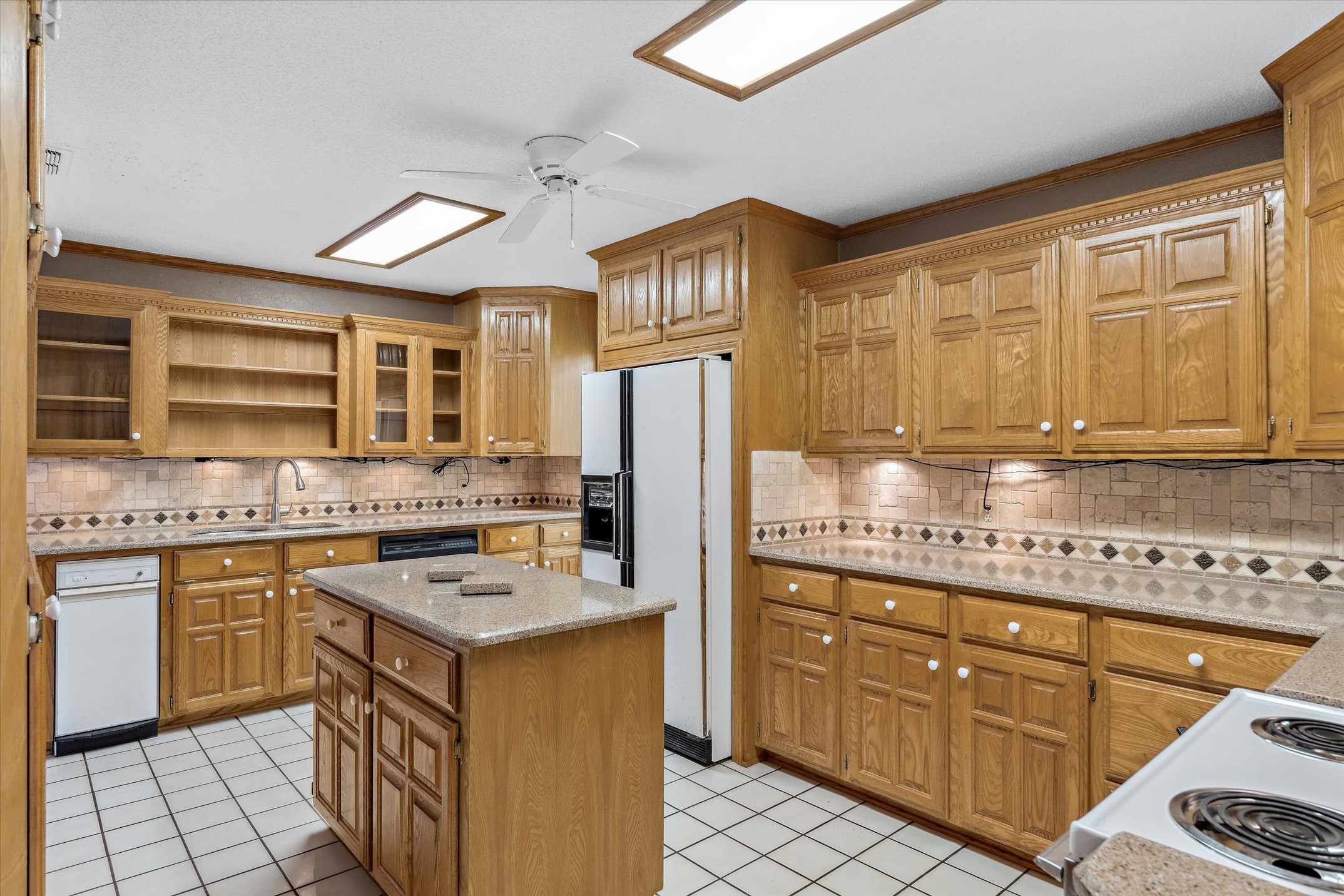 302 Erwin Street Edgewood, TX 75117 - Photo 12 of 40 a kitchen with stainless steel appliances granite countertop a stove refrigerator sink and cabinets