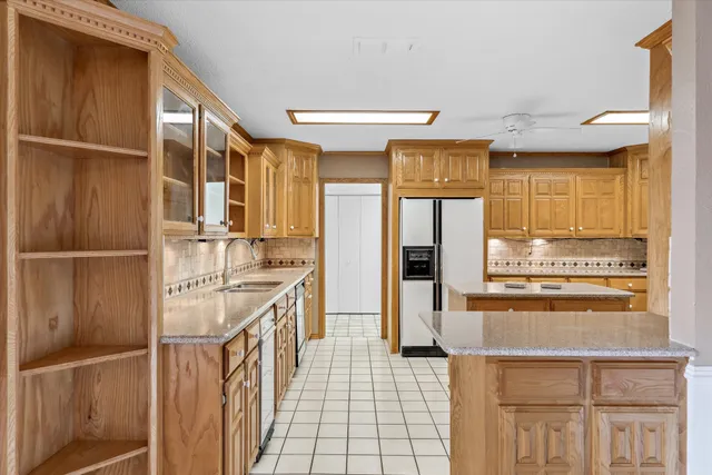 a kitchen with stainless steel appliances granite countertop a refrigerator and a stove