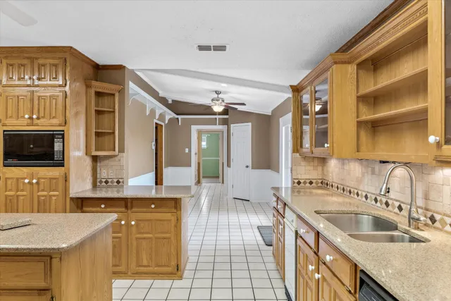 a kitchen with a sink stove and cabinets
