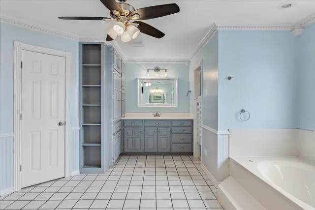a bathroom with a tub shower vanity and a sink