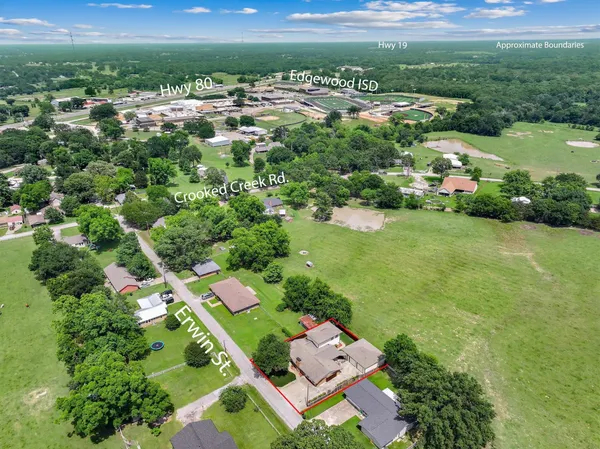 an aerial view of city lake and trees all around