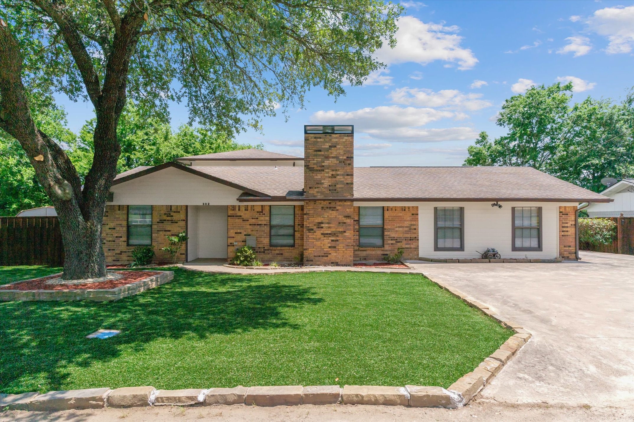 302 Erwin Street Edgewood, TX 75117 - Photo 9 of 40 a front view of a house with a yard and trees