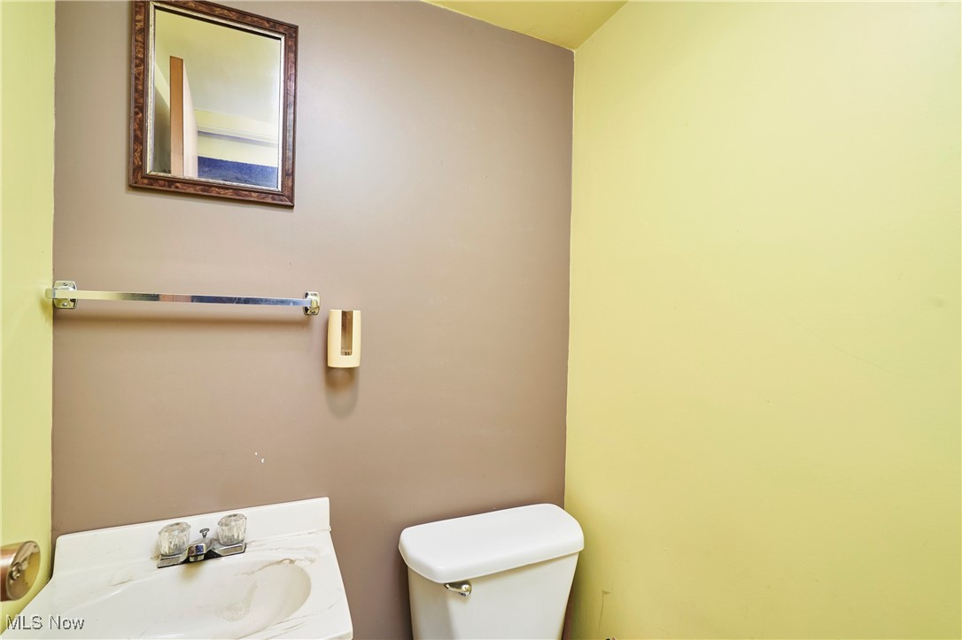 1129 Homestead Road Cleveland, OH 44121 - Photo 22 of 26 Half bath with toilet and vanity