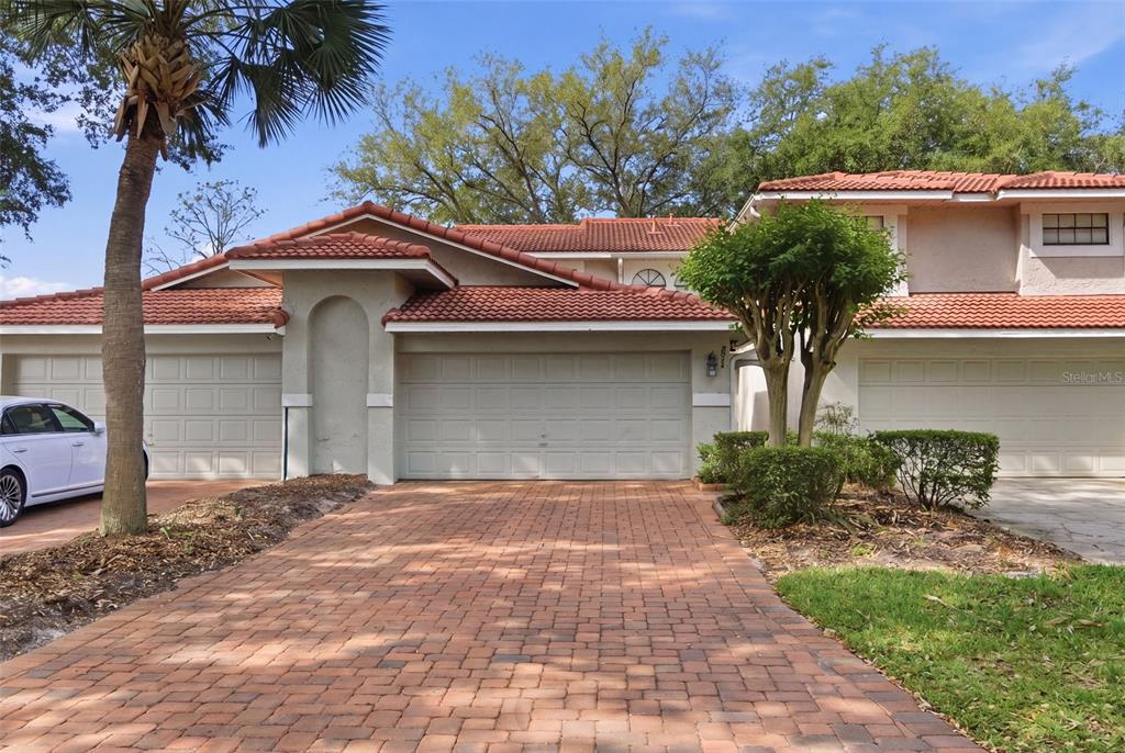 8044 Sandpoint Boulevard Orlando, FL 32819 - Photo 1 of 34 a front view of a house with garden