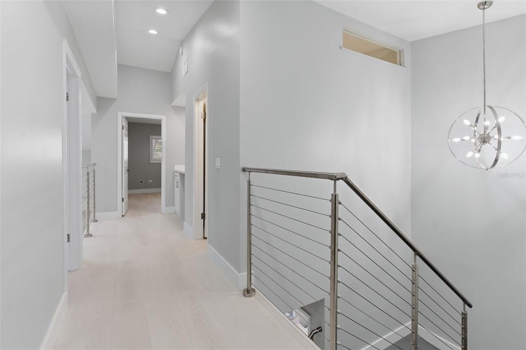8044 Sandpoint Boulevard Orlando, FL 32819 - Photo 16 of 34 a view of a hallway with wooden floor