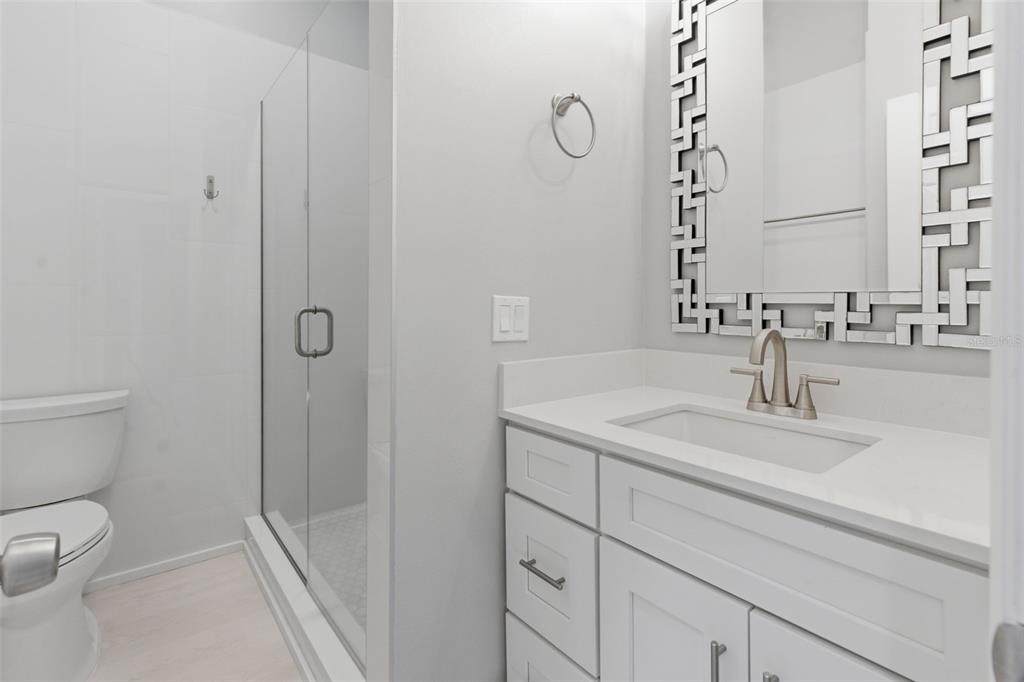8044 Sandpoint Boulevard Orlando, FL 32819 - Photo 20 of 34 a bathroom with a sink toilet and shower