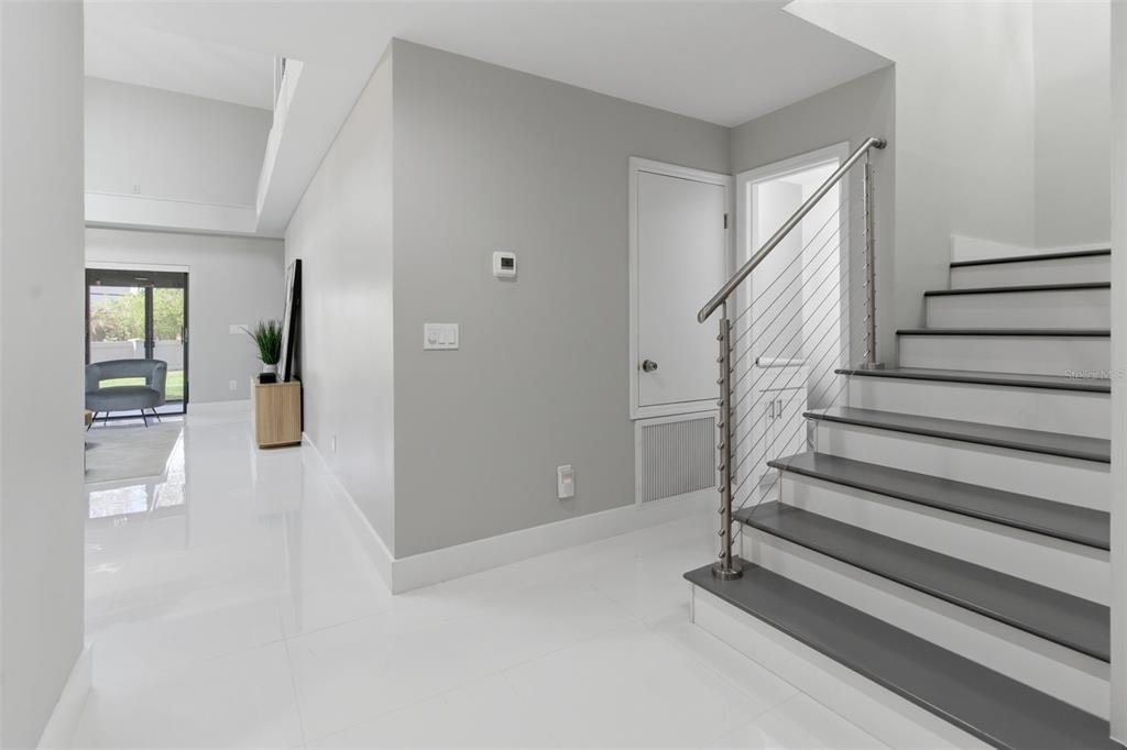 8044 Sandpoint Boulevard Orlando, FL 32819 - Photo 2 of 34 a view of an entryway with wooden floor and windows