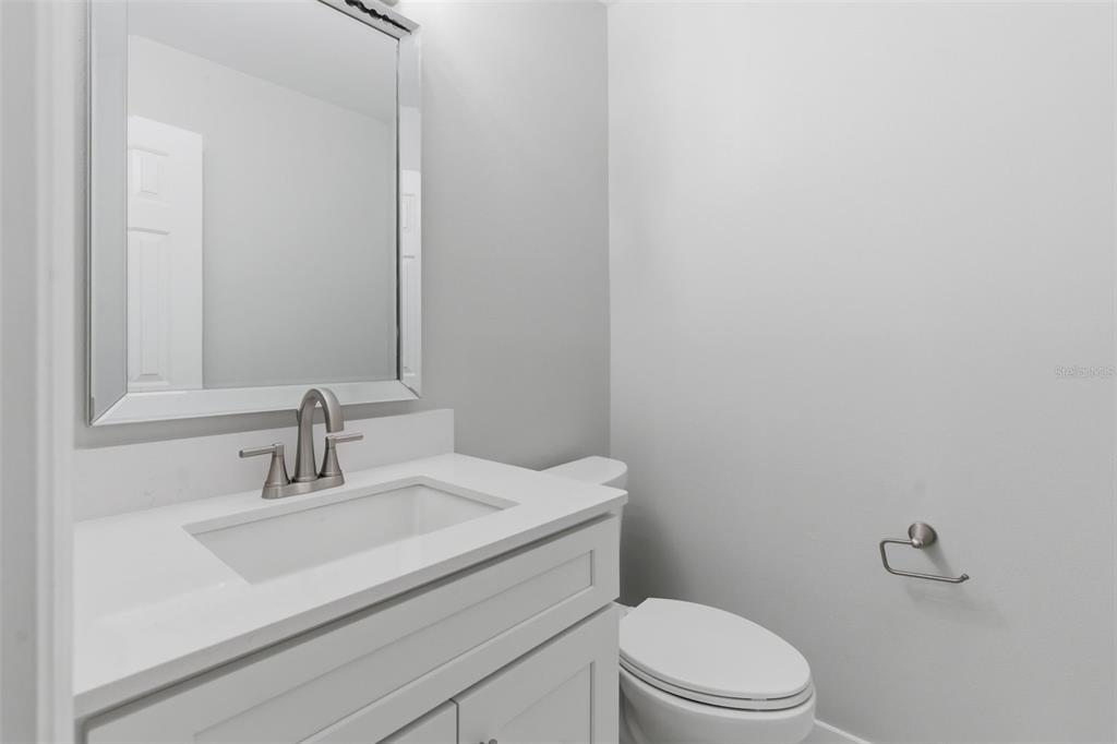 8044 Sandpoint Boulevard Orlando, FL 32819 - Photo 23 of 34 a bathroom with a sink a toilet and mirror