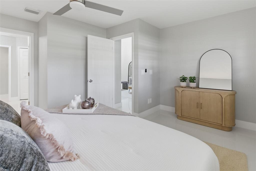 8044 Sandpoint Boulevard Orlando, FL 32819 - Photo 26 of 34 a bedroom with a bed and a dresser