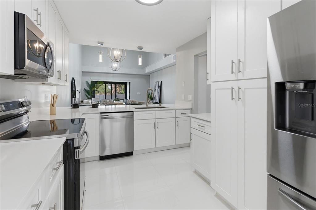 8044 Sandpoint Boulevard Orlando, FL 32819 - Photo 10 of 34 a kitchen with white cabinets and white appliances