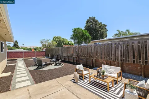 a view of a patio with table and chairs with wooden floor and fence
