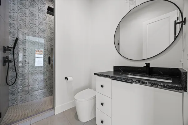 a bathroom with a sink a mirror and a shower