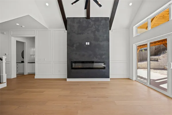 a view of empty room with wooden floor