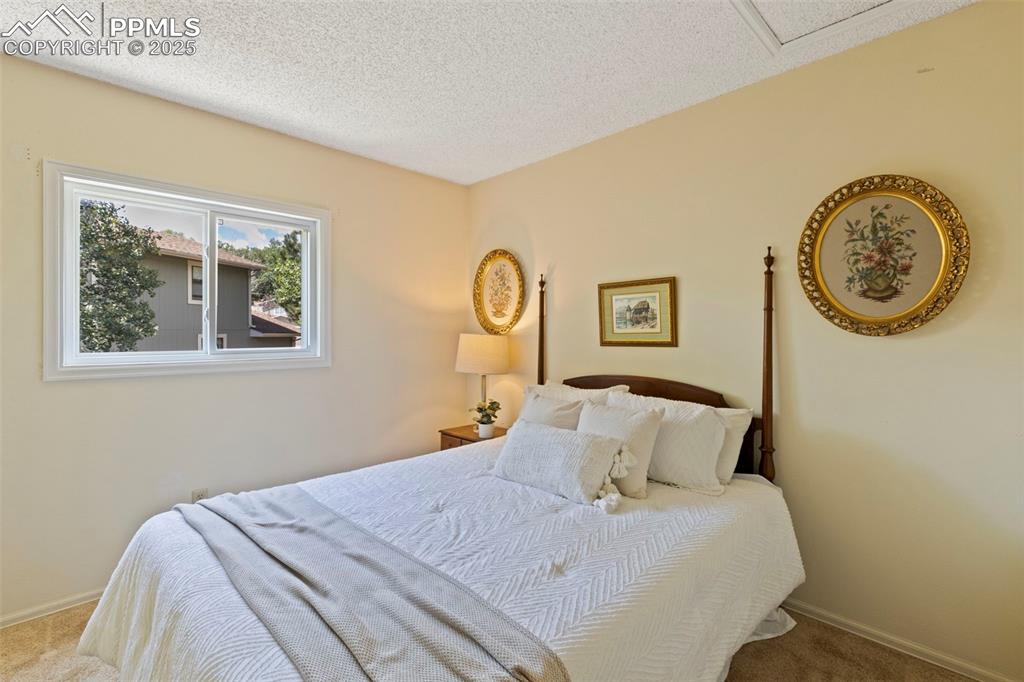 2113 Roundtop Court Colorado Springs, CO 80918 - Photo 20 of 34 a bedroom with a bed and a wall painting