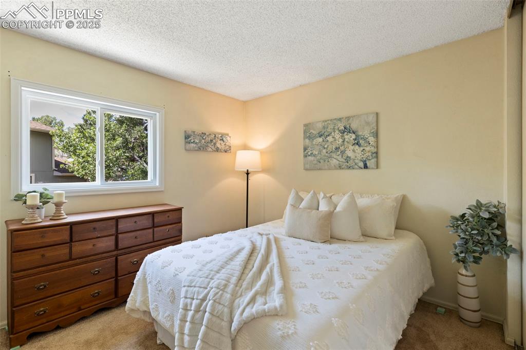 2113 Roundtop Court Colorado Springs, CO 80918 - Photo 22 of 34 a bedroom with a bed and a window