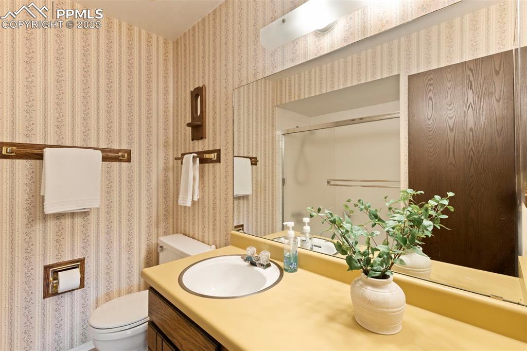 2113 Roundtop Court Colorado Springs, CO 80918 - Photo 29 of 34 a bathroom with a granite countertop sink and a mirror