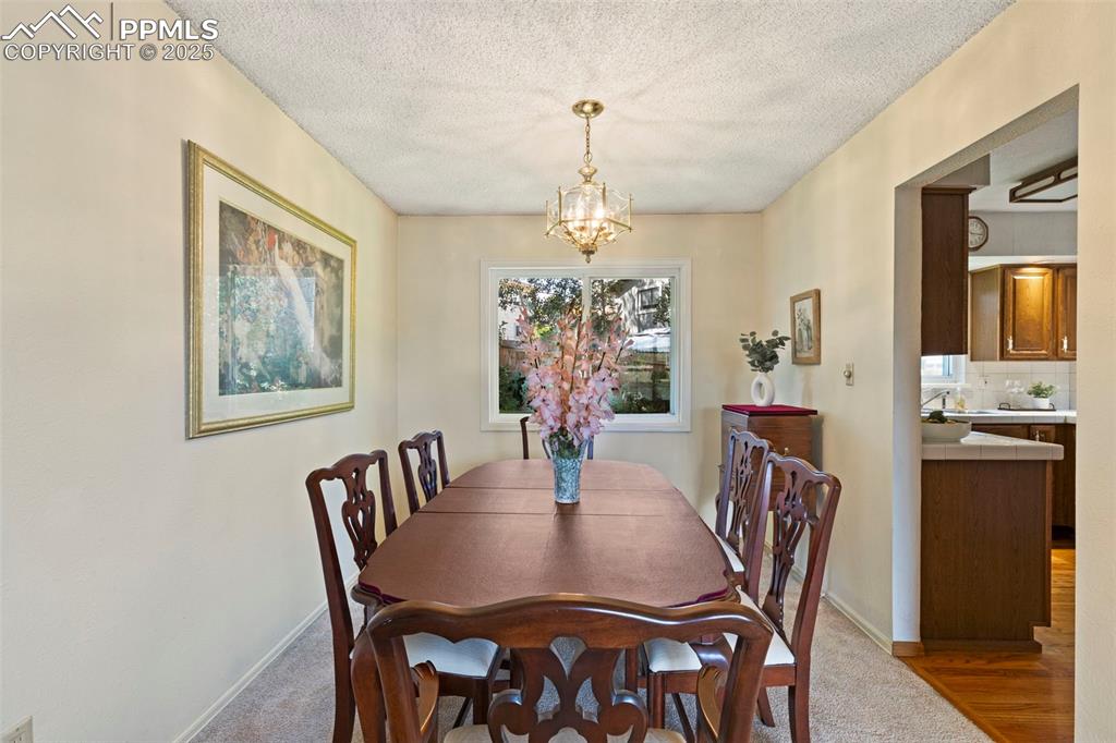2113 Roundtop Court Colorado Springs, CO 80918 - Photo 6 of 34 a view of a dining room with furniture window and wooden floor