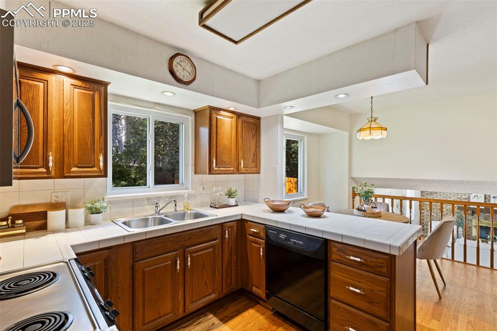 2113 Roundtop Court Colorado Springs, CO 80918 - Photo 7 of 34 a kitchen with a sink cabinets and window