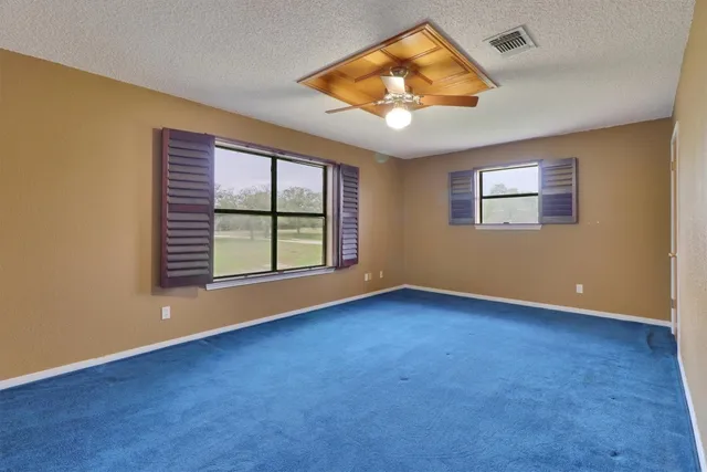 an empty room with a empty space and a ceiling fan