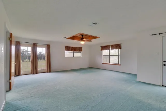 an empty room with closet and entertaining space