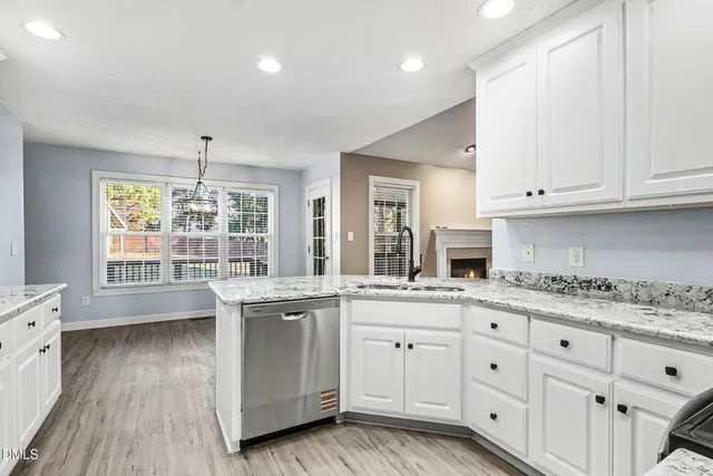 a kitchen with stainless steel appliances granite countertop a refrigerator and sink