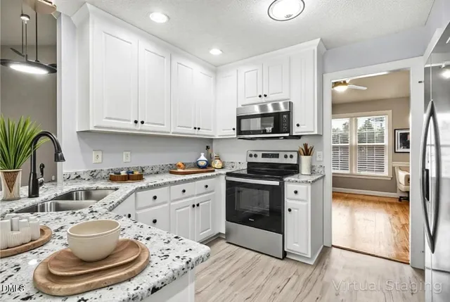 a kitchen with a refrigerator and chandelier