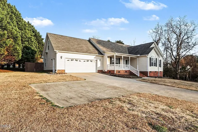 a view of a house with a snow on the road