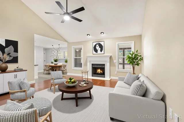 a living room with furniture a fireplace and a flat screen tv