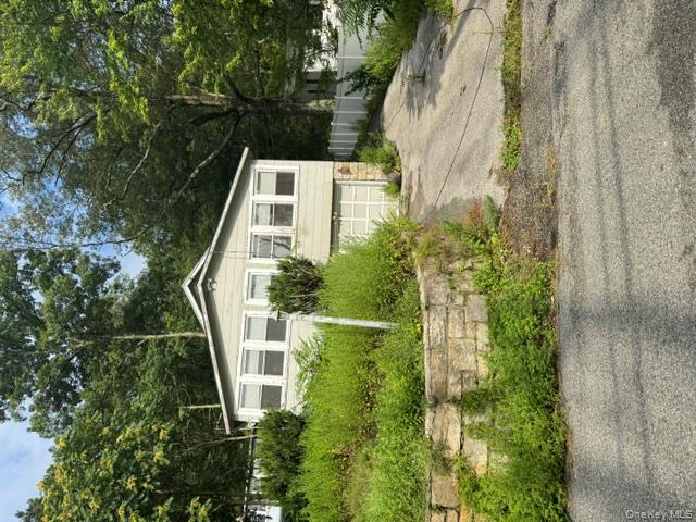 157 Tanglewylde Road Lake Peekskill, NY 10537 - Photo 1 of 13 a front view of a house with a yard