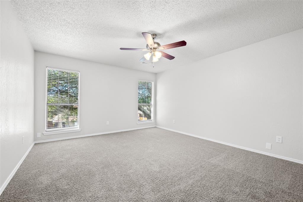 7501 Kings Ridge Road Frisco, TX 75035 - Photo 14 of 27 an empty room with windows and fan