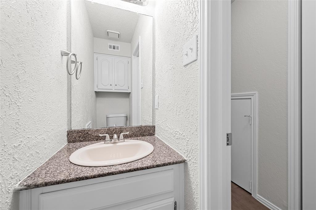 7501 Kings Ridge Road Frisco, TX 75035 - Photo 20 of 27 a bathroom with a granite countertop sink and a mirror