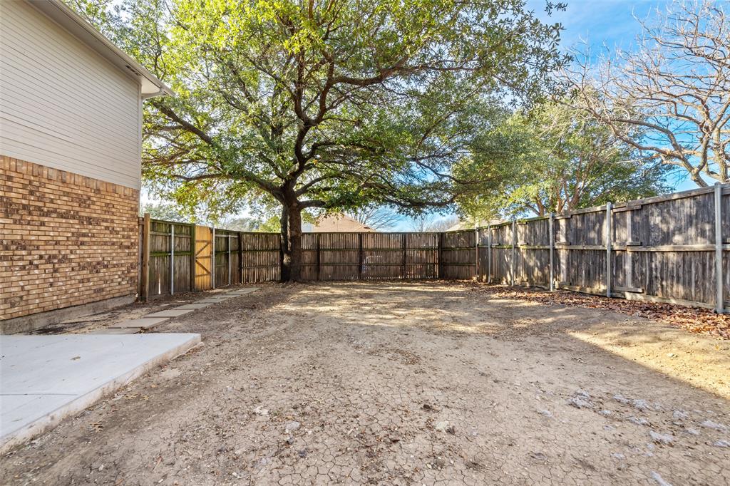 7501 Kings Ridge Road Frisco, TX 75035 - Photo 23 of 27 a view of a backyard with large trees