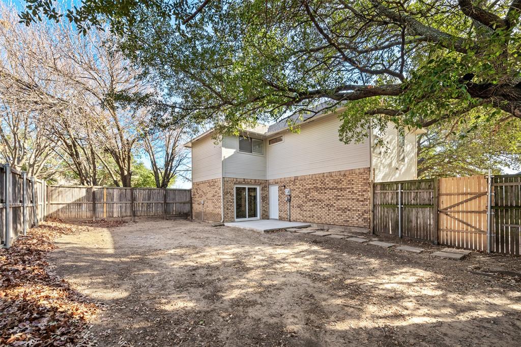 7501 Kings Ridge Road Frisco, TX 75035 - Photo 24 of 27 a view of a house with a large tree and wooden fence