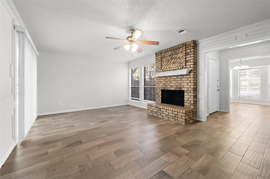 7501 Kings Ridge Road Frisco, TX 75035 - Photo 7 of 27 a view of an empty room with a fireplace and a window