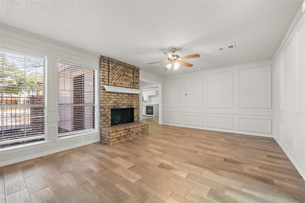 7501 Kings Ridge Road Frisco, TX 75035 - Photo 8 of 27 a view of an empty room with a fireplace and a window