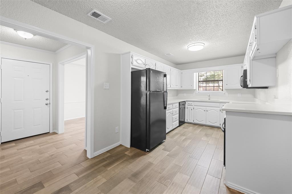 7501 Kings Ridge Road Frisco, TX 75035 - Photo 10 of 27 a kitchen with a refrigerator and a sink