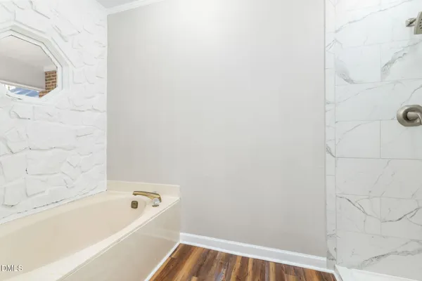 a bathroom with a granite countertop double vanity sink and a mirror