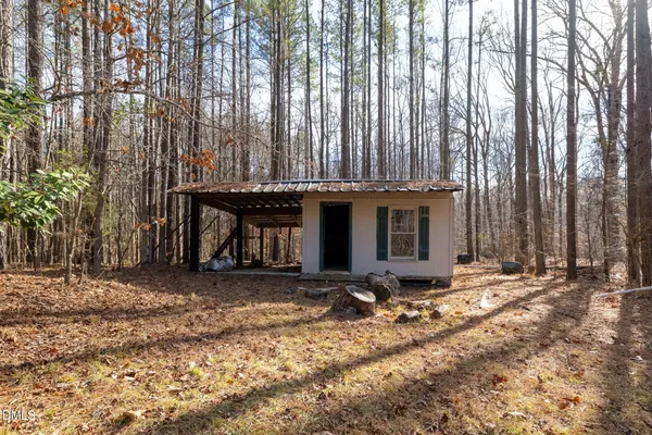 a view of a house with a yard and wooden fence