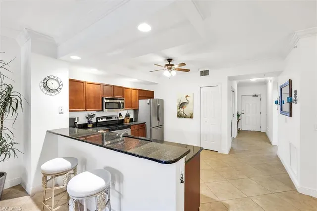 a kitchen with a sink a stove and chairs