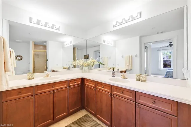 a bathroom with a sink double vanity granite and a mirror