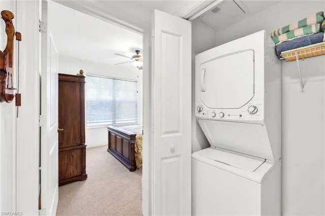 a view of washer and dryer with bathroom in the background