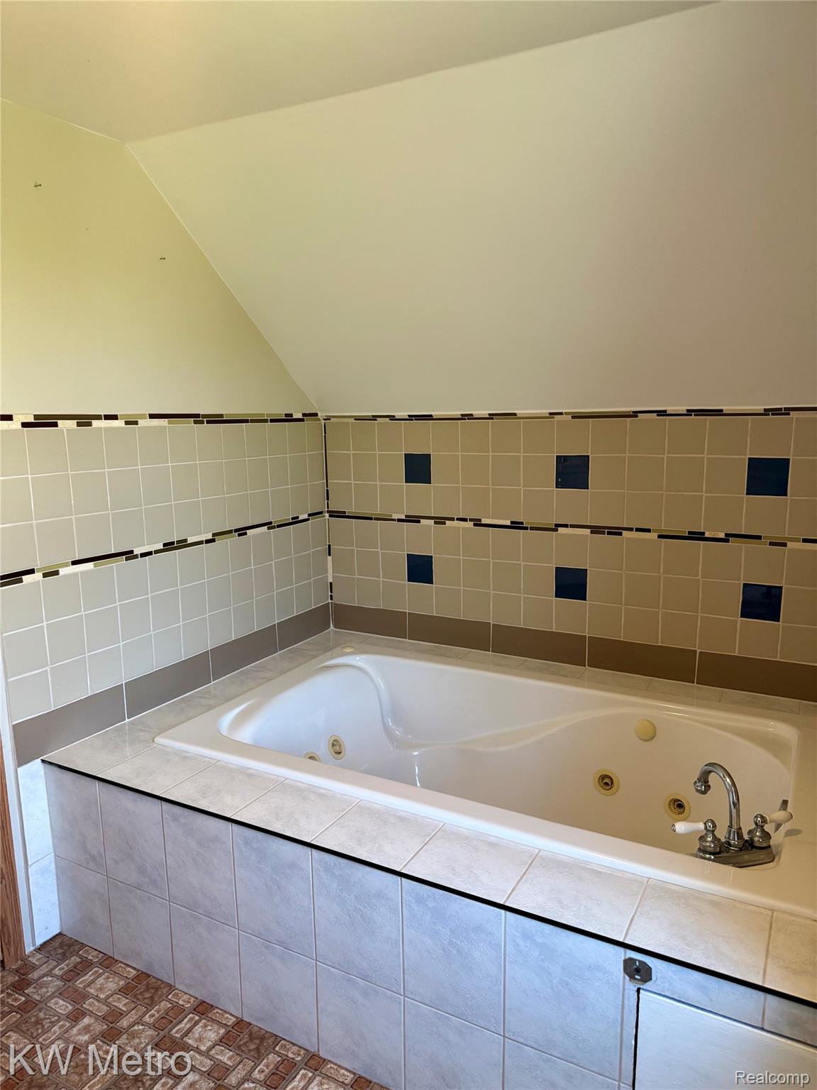 5982 South Mission Road Mount Pleasant, MI 48858 - Photo 29 of 32 Full bathroom featuring a jetted tub and vaulted ceiling
