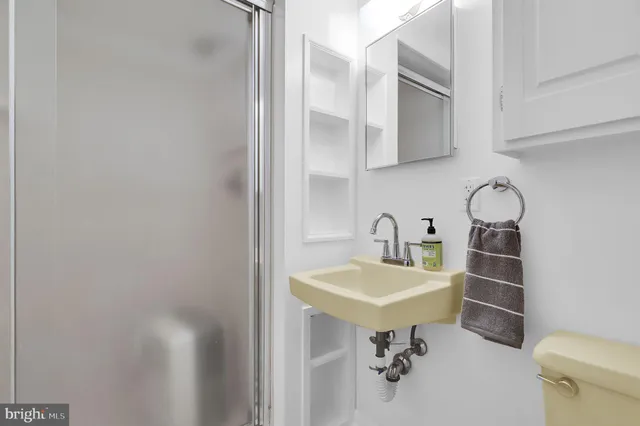 a bathroom with a sink a toilet and mirror