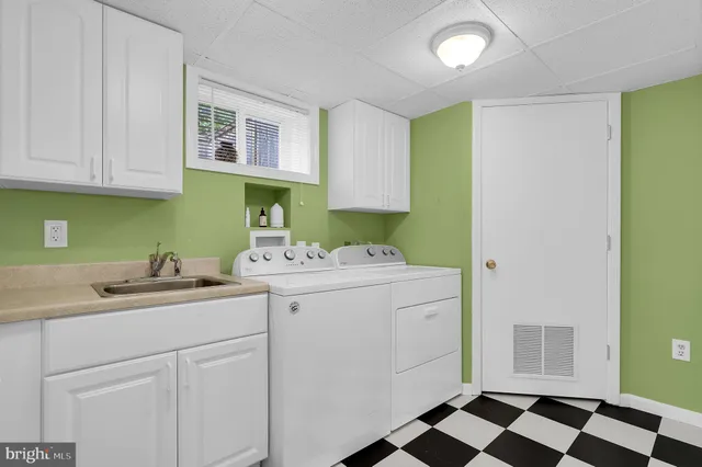 a utility room with a sink dryer and washer