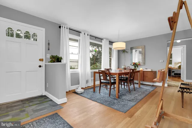 a view of a a dining room with furniture window and wooden floor
