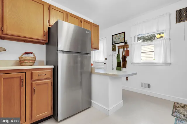a kitchen with stainless steel appliances a refrigerator and a sink