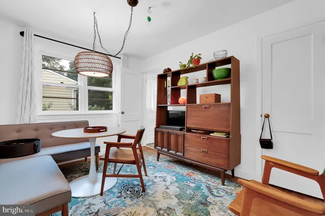 a dining room with furniture and window