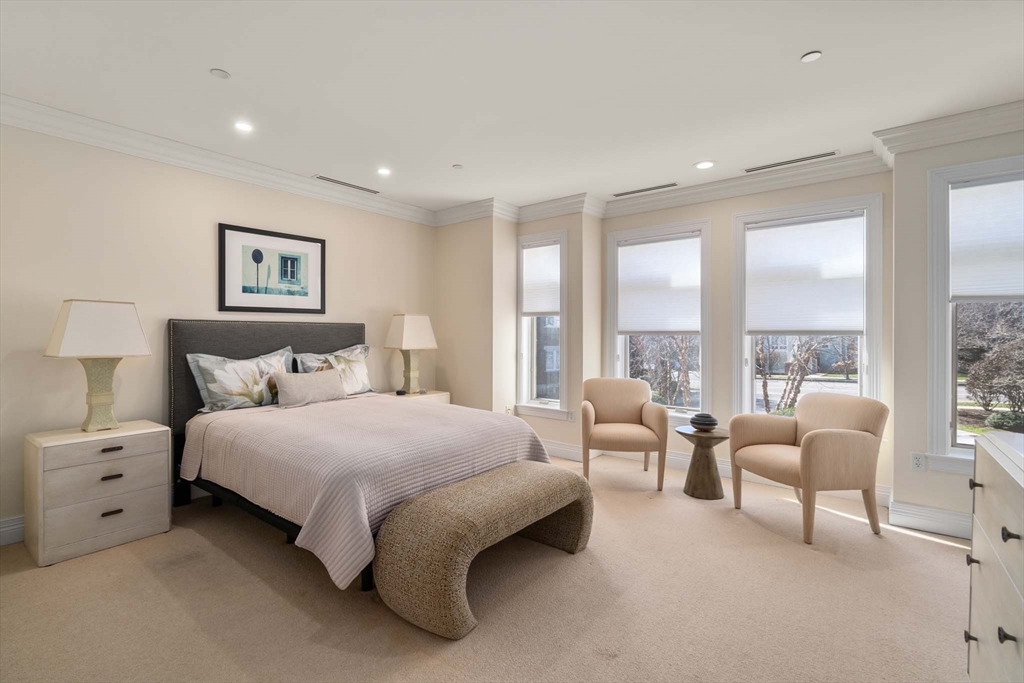 630 Hammond Street, Unit 102 Brookline, MA 02467 - Photo 12 of 19 a spacious bedroom with a bed and glass walk in closet