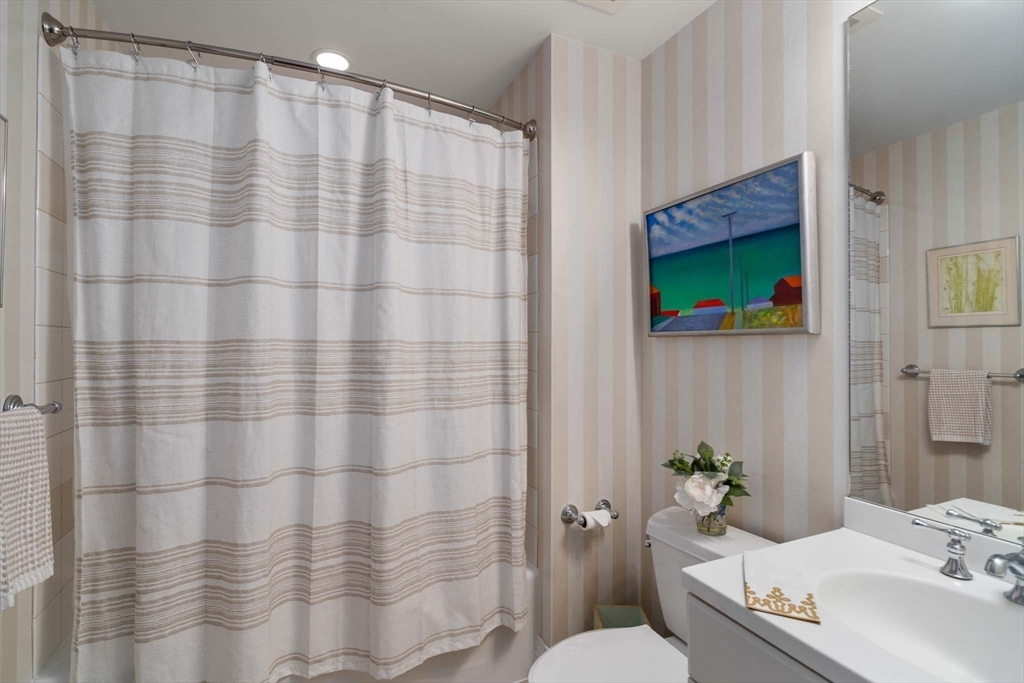 630 Hammond Street, Unit 102 Brookline, MA 02467 - Photo 17 of 19 a bathroom with a sink and a mirror